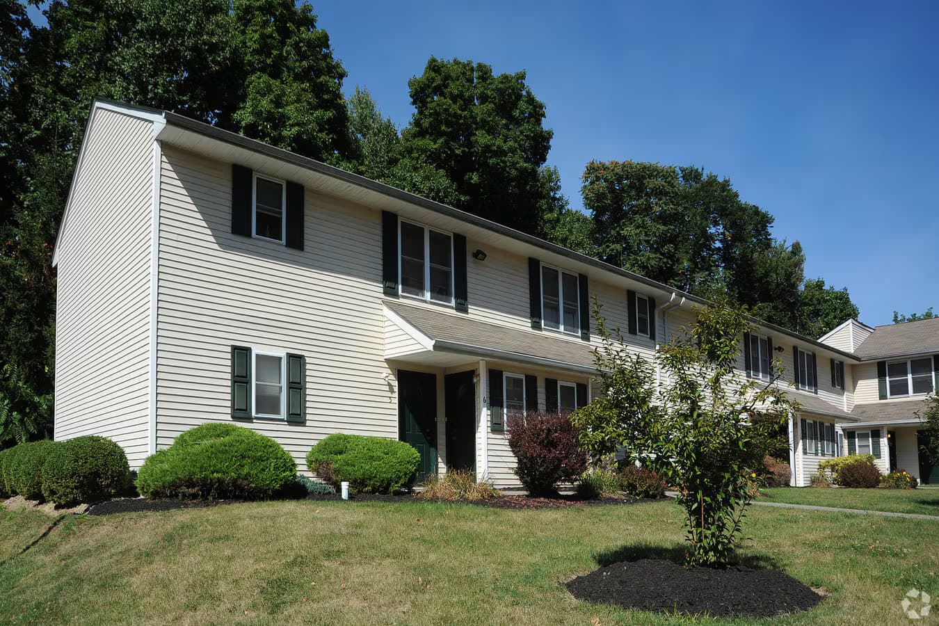 Academy Hill Apartments exterior with lawn and walkway